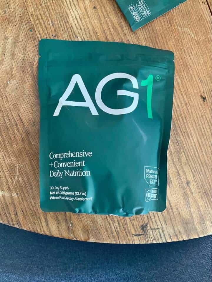 AG1 vs Seed: The AG1 welcome kit, also known as Athletic Greens, with its pouch and canister.