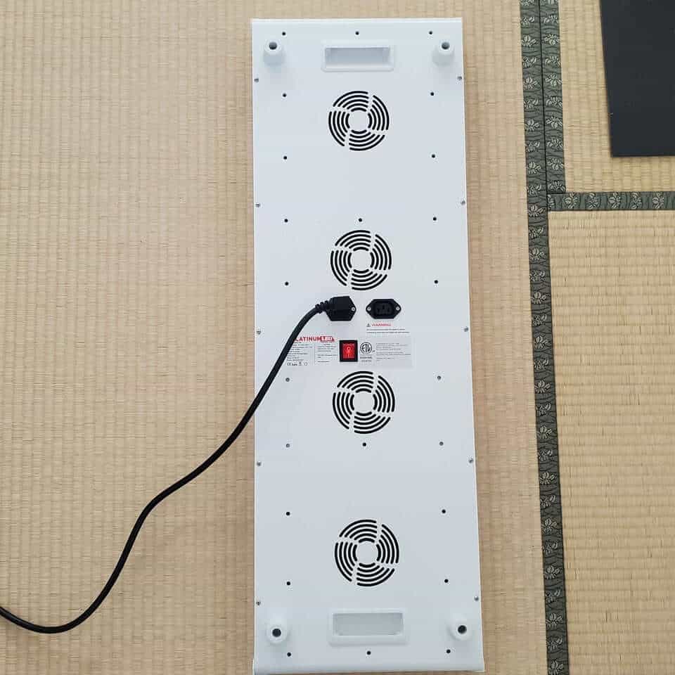 A person using the PlatinumLED BioMax 900 panel correctly for a therapy session.