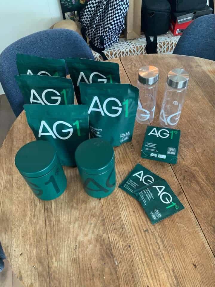 A person holding both Seed and AG1 products to compare seed probiotics vs ag1.