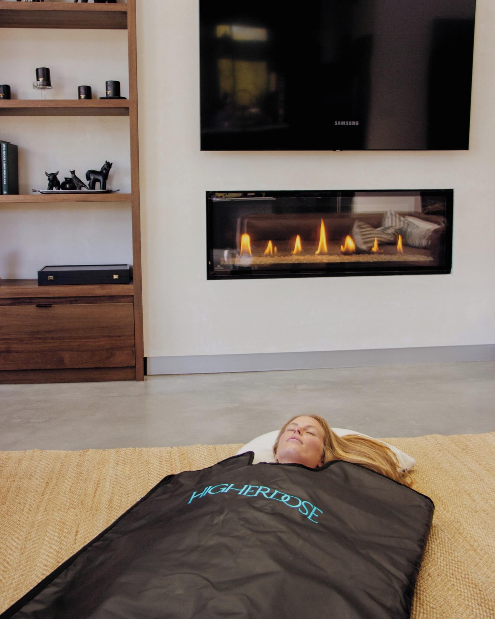 A man using the HigherDose infrared sauna blanket