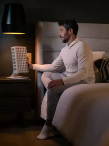 a man using a low emf red light therapy device from orion