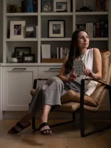 a woman is using the orion pro 300 to produce red light phototherapy