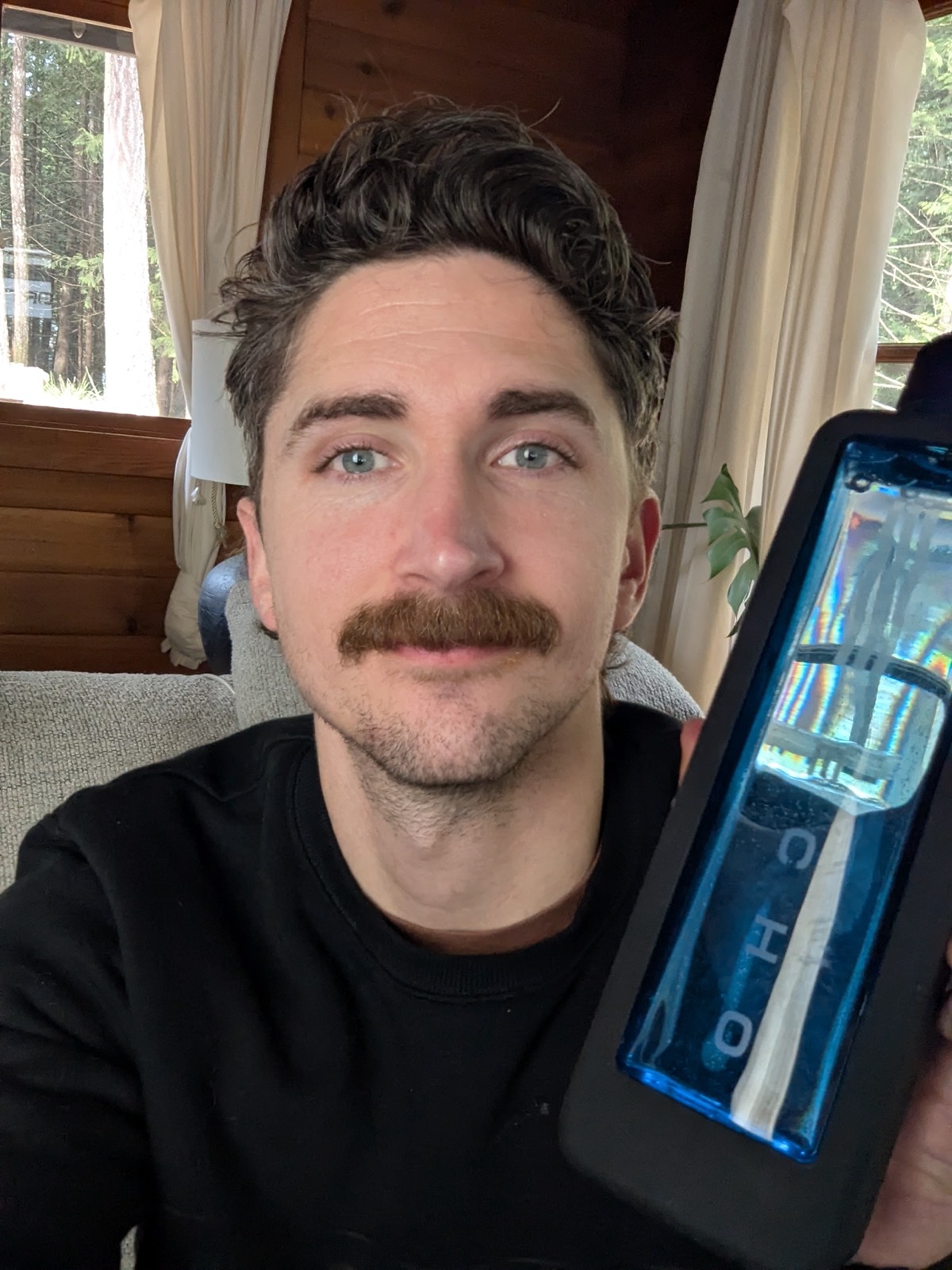 an echo hydrogen water bottle next to daryls face