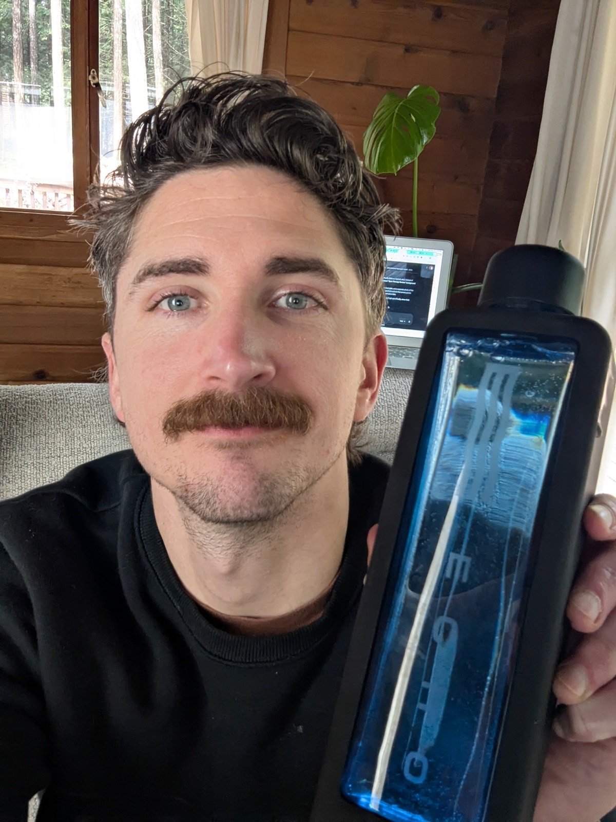 an echo hydrogen water bottle on next to daryls face