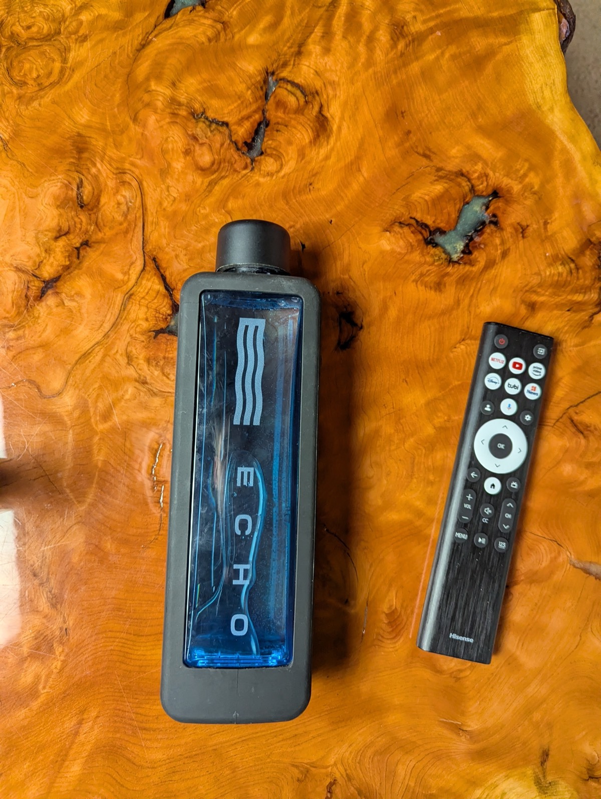 comparing the ehco hydrogen water next to a remote for sizing