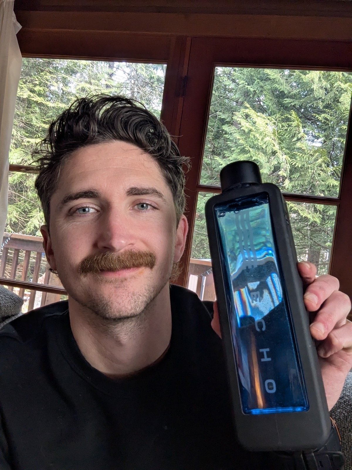 daryl holding a hydrogen echo water bottle beside his face