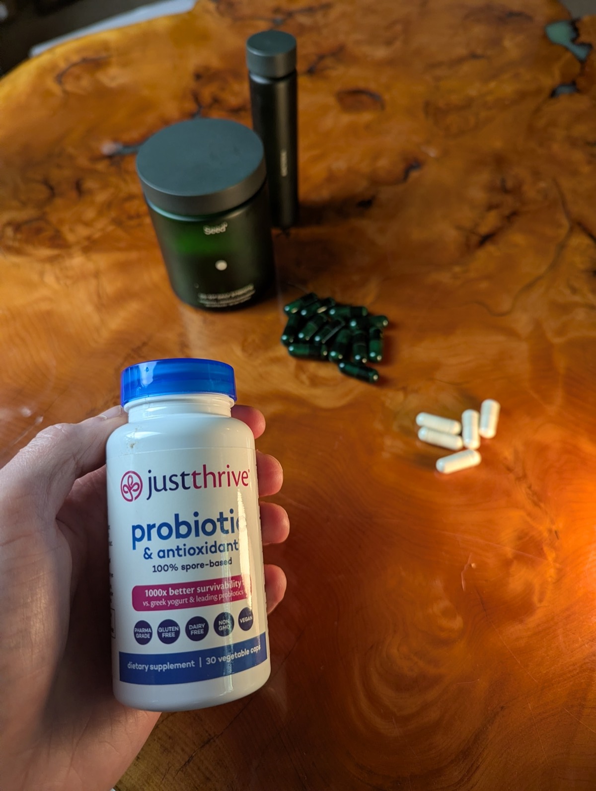 daryl holding just thrive probiotic with seed ds 01 in the background