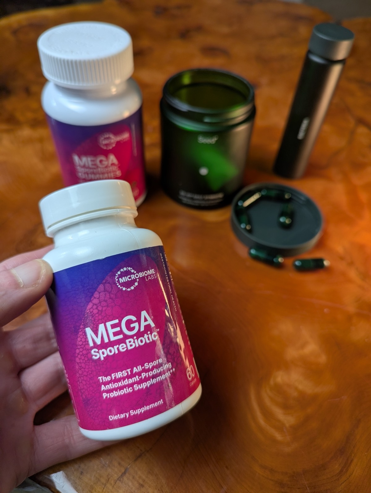 daryl holding megasporebiotic with seed probiotic in the background 