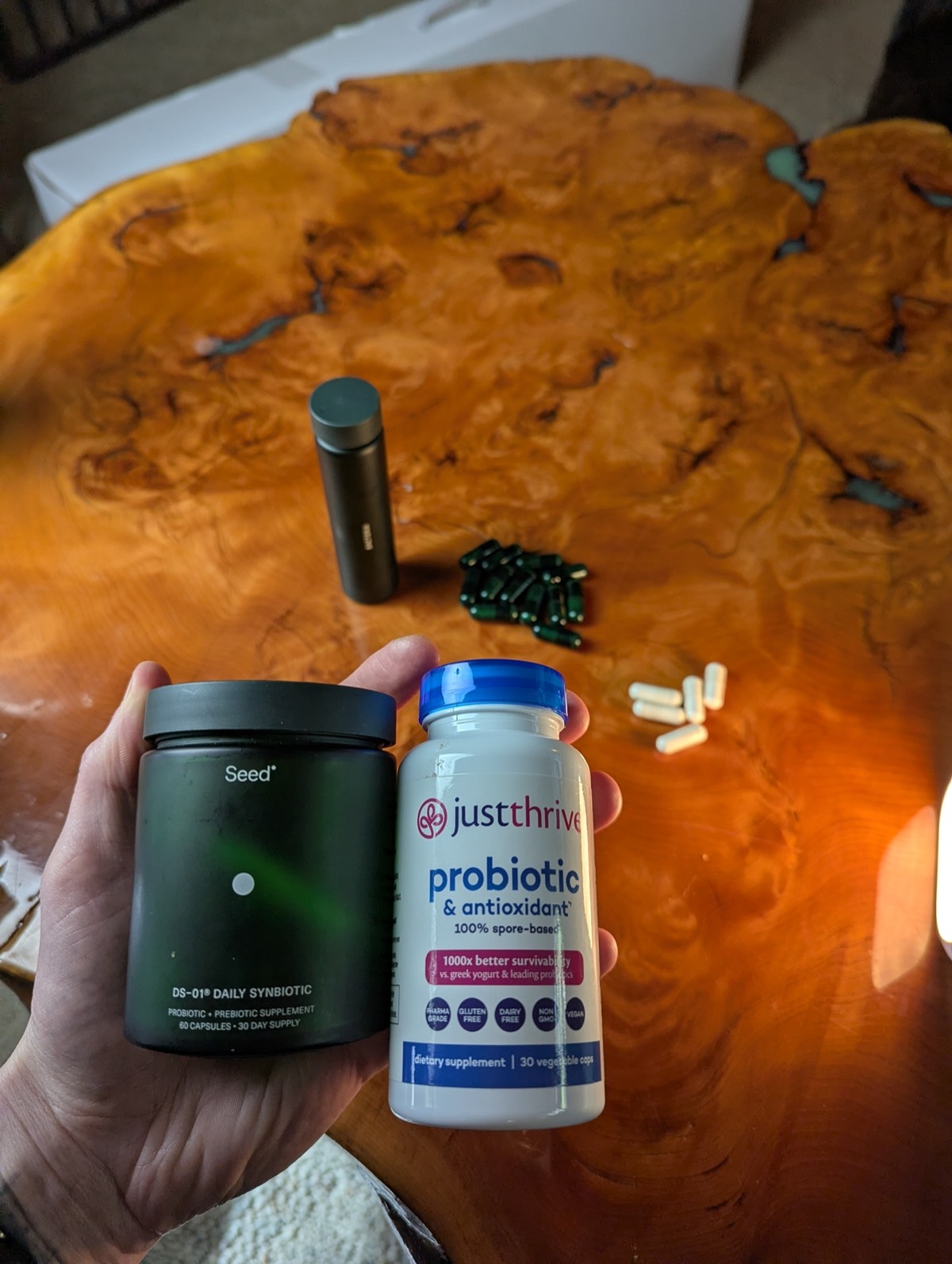 daryl holding seed and just thrive probiotic in his hand 