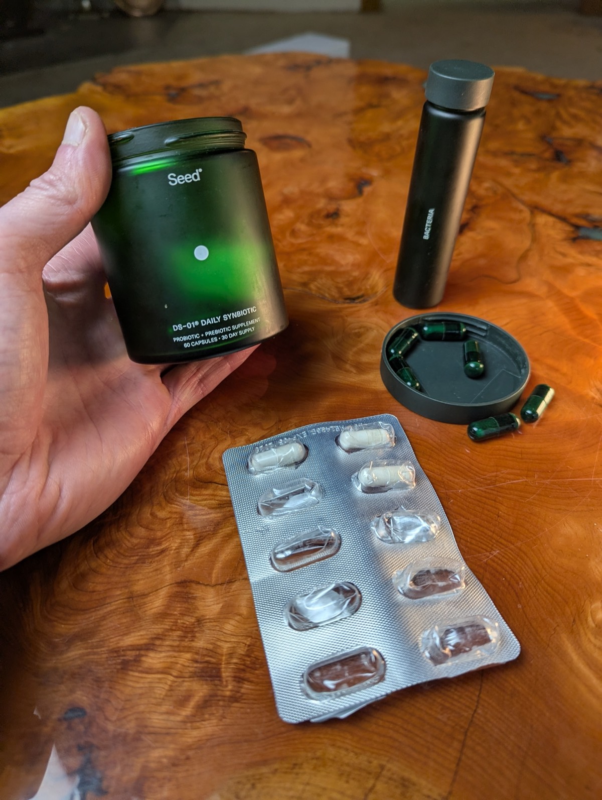 daryl holding seed probiotic with probiotic on the coffee table
