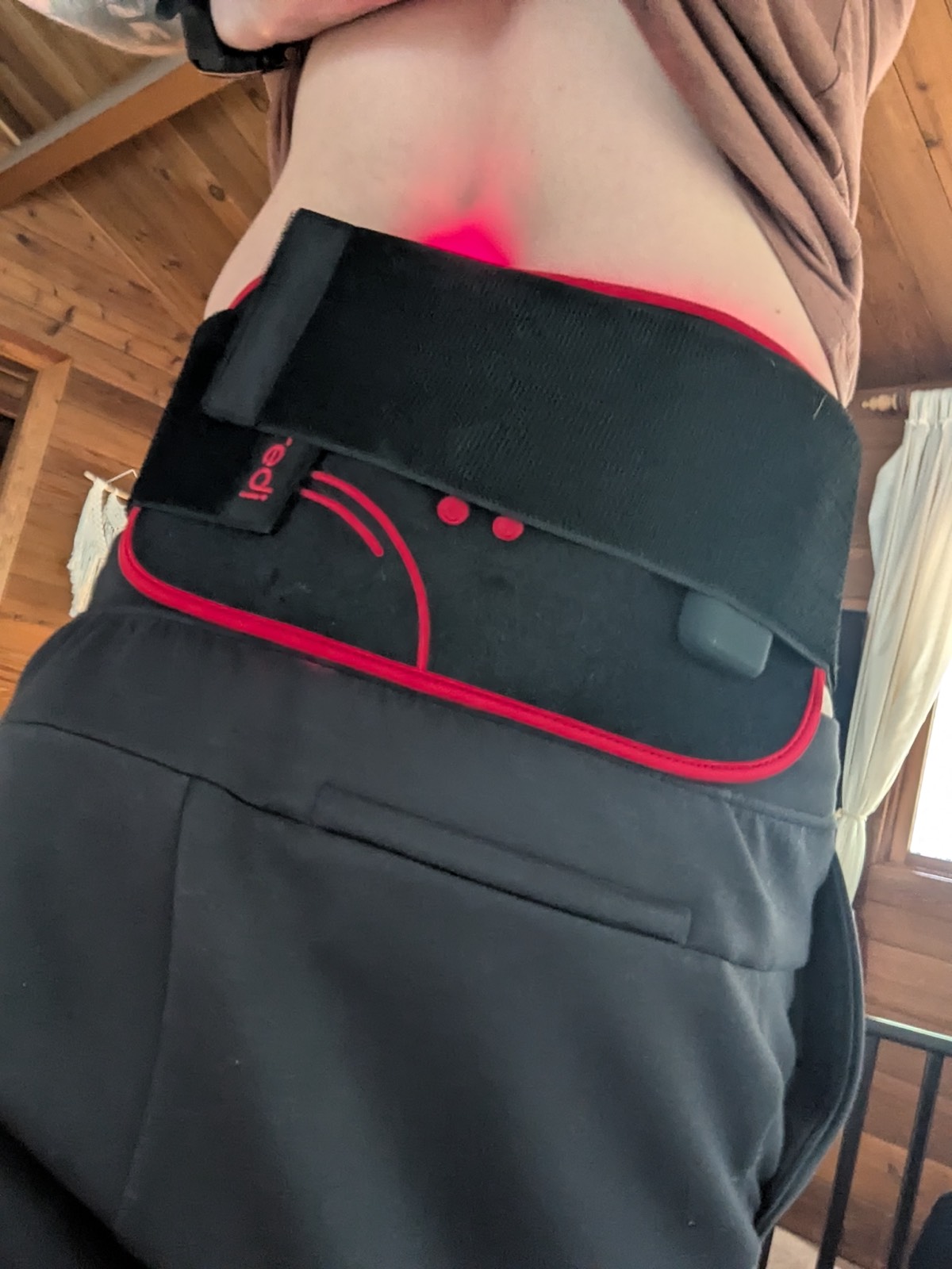 daryl wearing a red light therapy belt for back pain