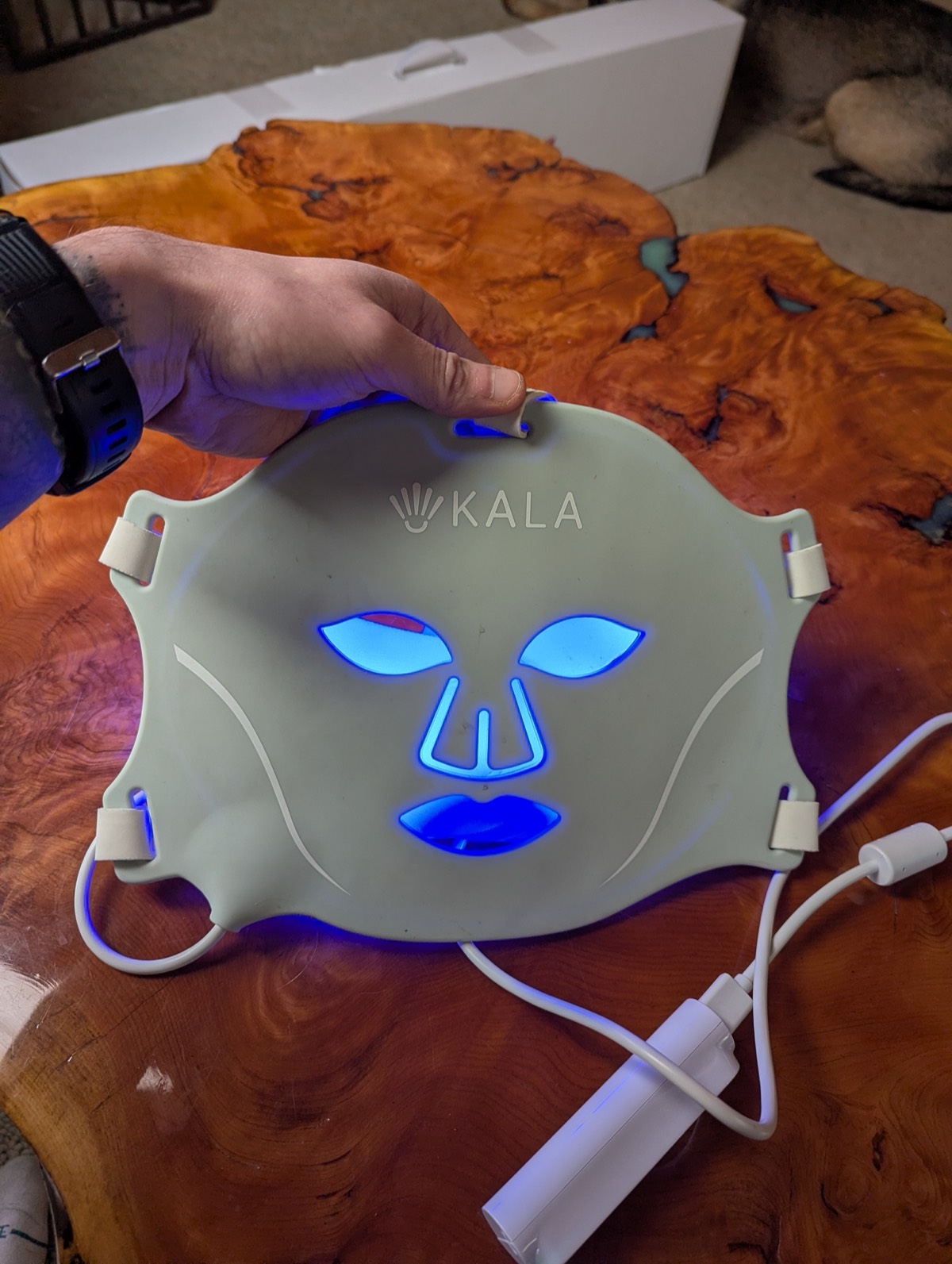 front of kala red light therapy mask with th eblue light on