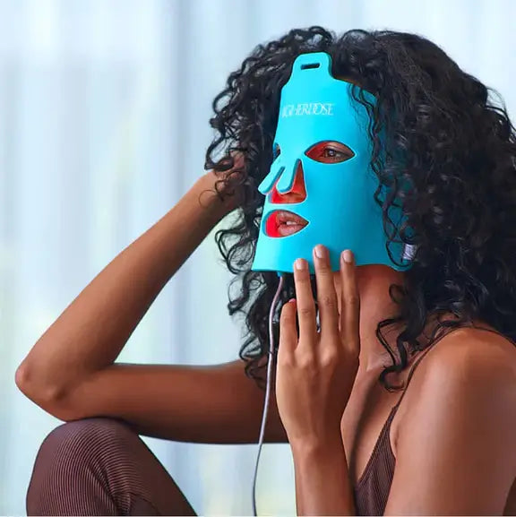 The HigherDOSE red led mask shown on a surface, highlighting its flexible silicone design.