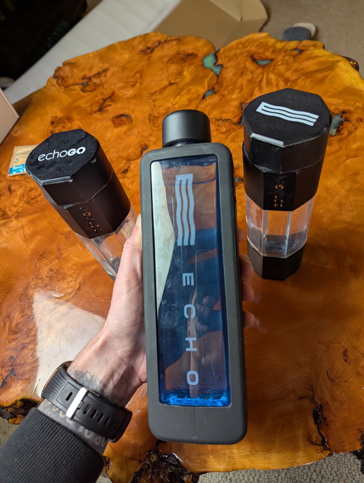 holding hydrogen water bottles 
