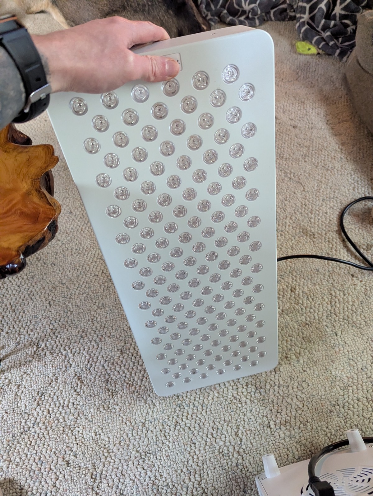 showing off a red lgiht therapy panel in canad