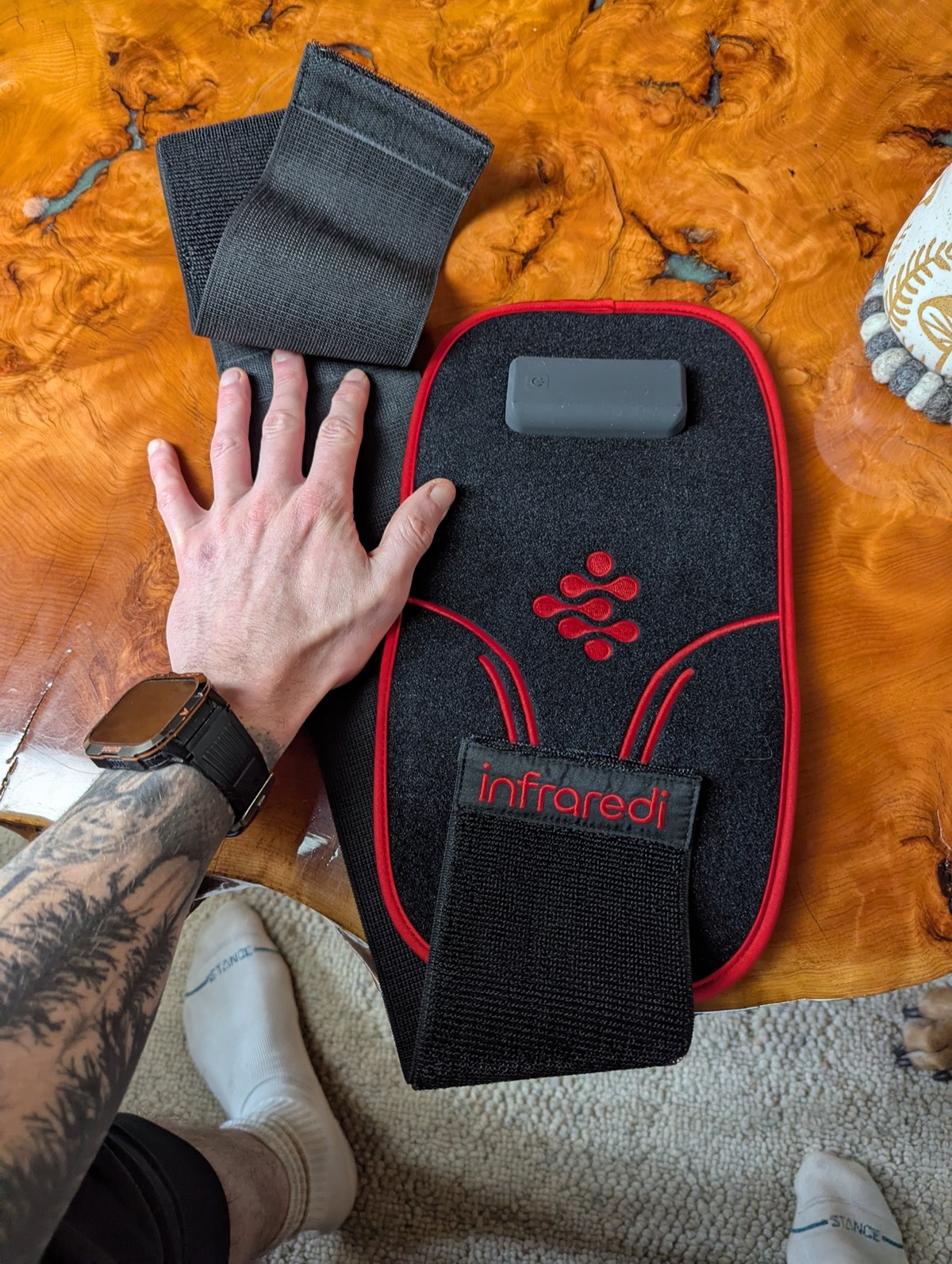 showing the size of the infraredi joint therapy pad next to his hand