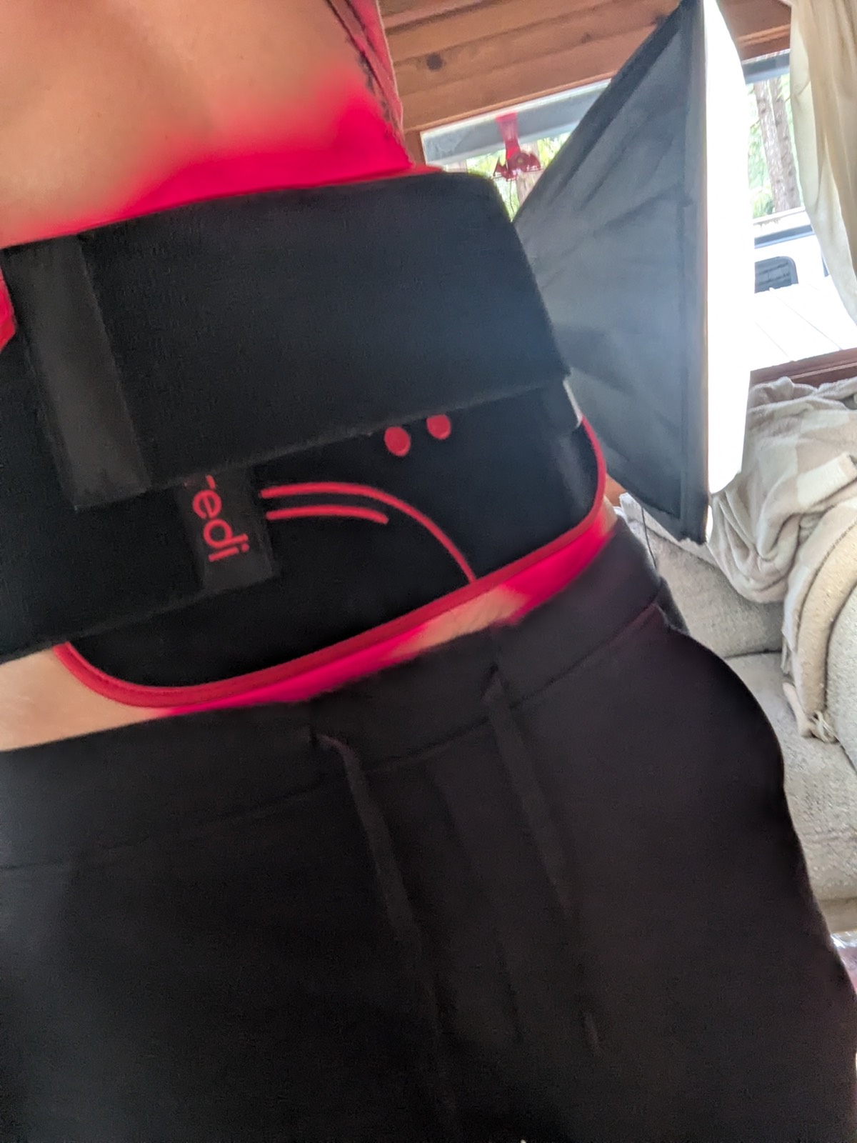 wearing a red light therapy belt on my tummy and stomach