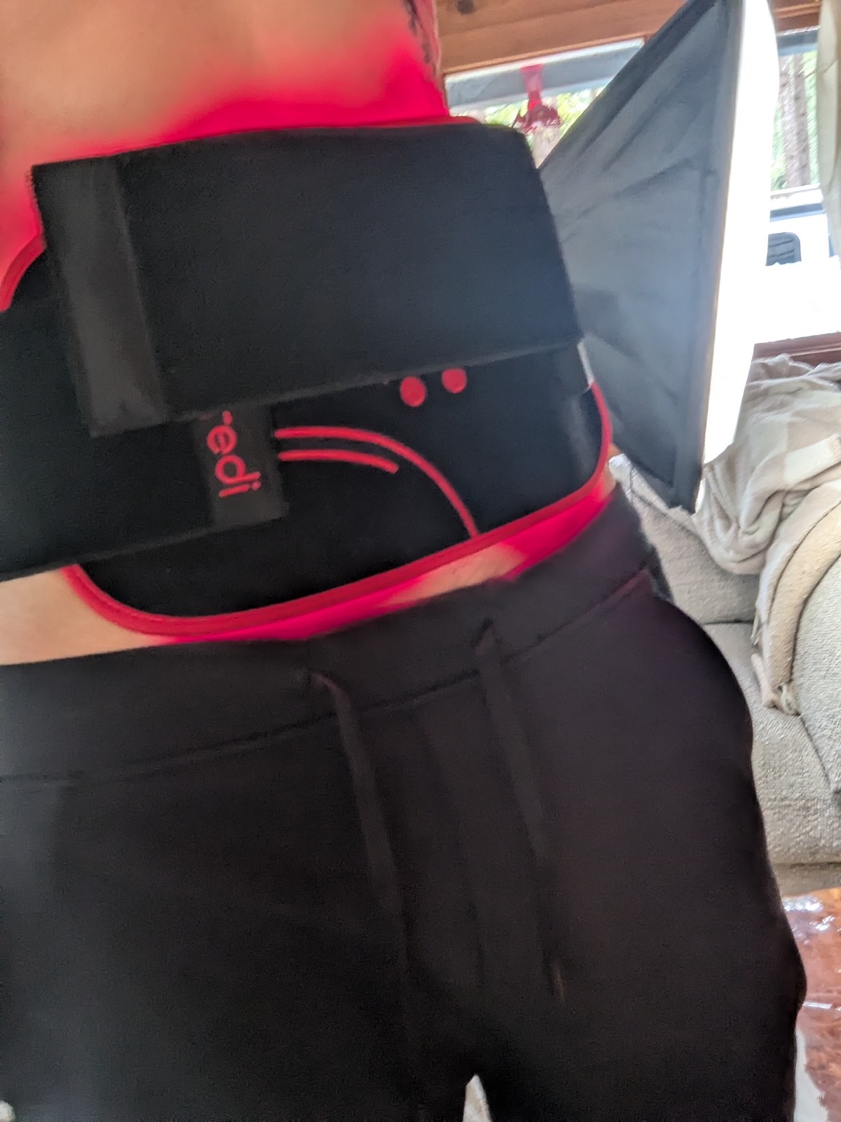 wearing red light therapy pad for back pain 